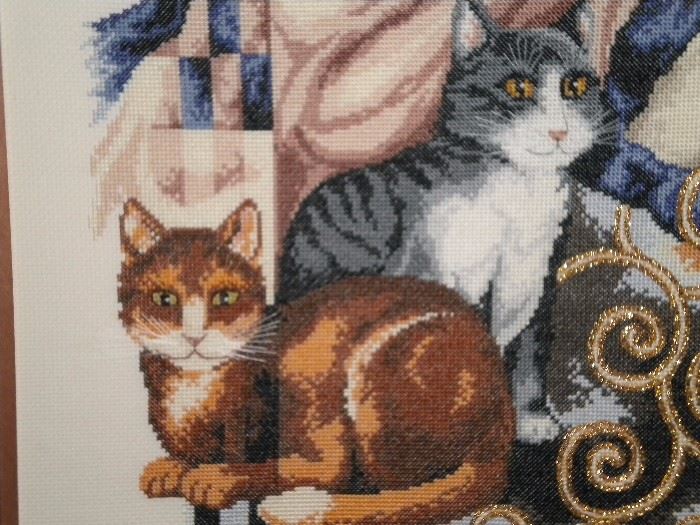 Framed cross stitch lady with 2 cats and gold trim