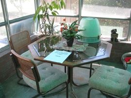Glass top table with four cushioned chairs.