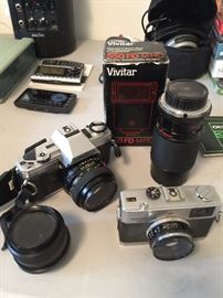 Minolta camera with accessories and Olympus camera