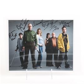 Autographed Photo of the Cast of "Breaking Bad": A photograph of the cast members of Breaking Bad. This studio photograph of the cast features actors Bryan Cranston and Aaron Paul and is hand signed in black sharpie.