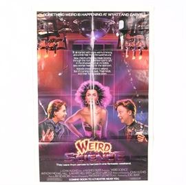 1985 "Weird Science" Movie Poster: An original movie poster for the 1985 Universal film Weird Science. The poster features the images of lead actors Anthony Michael Hall, Ilan Mitchell-Smith and Kelly LeBrock to the front. The poster also includes film credits, title and movie taglines.