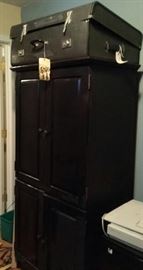large black cabinet... old luggage, etc.