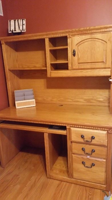 Oak desk.  3 drawers with shelved hutch.
