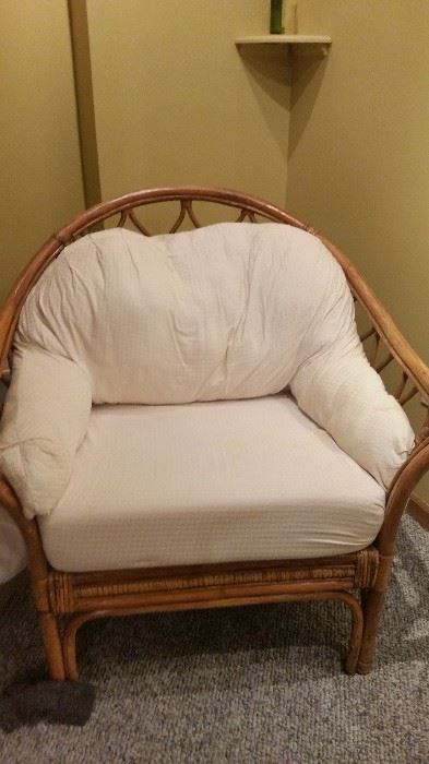 Wicker chair with white cushions