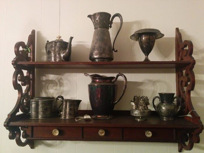 Hanging shelf and silverplated serving pieces