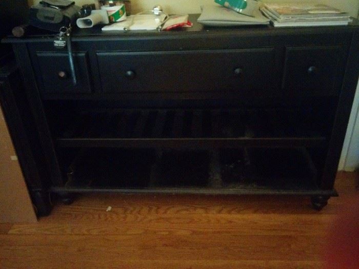 Black console table with drawers and shelves