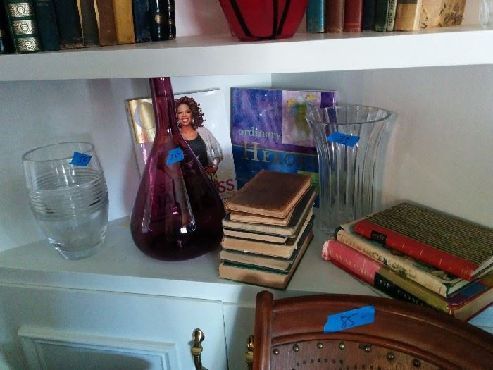 Amethyst glass and clear glass vases; lots of books
