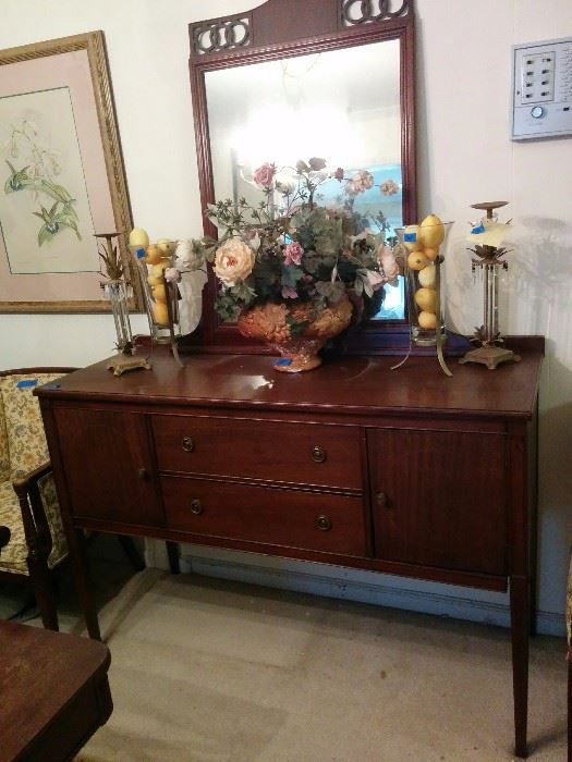 Sideboard/buffet; mirror; floral arrangement;  vases; candlesticks