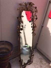 long metal mirror with leaf design, just needs a good cleaning 