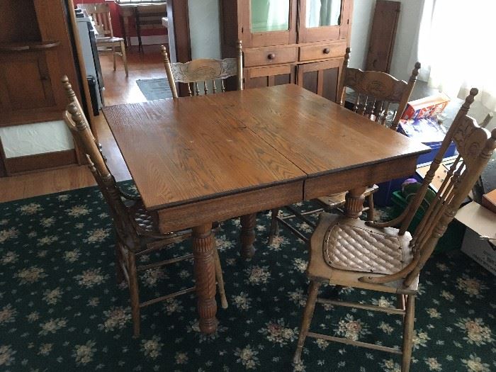 Oak table with 4 chairs.  Floral rug is also for sale