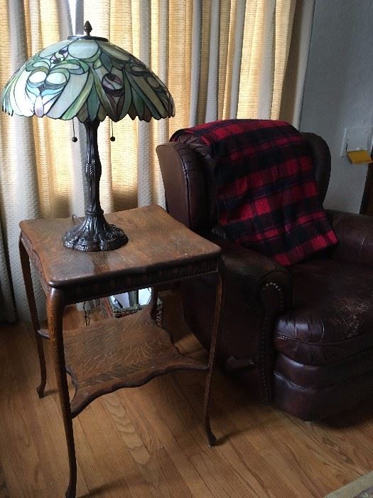 Leather arm chair, square oak side table and leaded glass shade lamp
