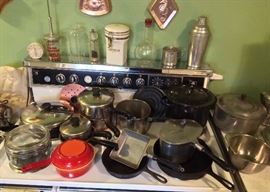 Pots & pans including Pyrex Flameware sauce pan, orange Descoware pan with skillet lid, Revere Ware, cast iron skillets, Club aluminum pans, vintage timer, food chopper jar, food molds