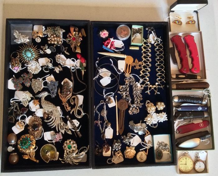 Costume jewelry including rhinestone brooches (peacock pin is SOLD), charm bracelets, dress clips, a few earrings & pocket watches. Also pocket knives.