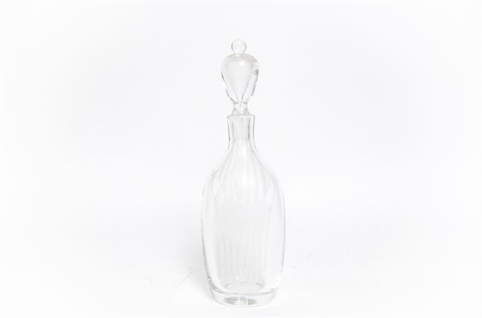 Kosta Boda Signed Ernest Gordon Lady Decanter: A Kosta Boda glass decanter. This piece is signed Ernest Gordon and features an etched form of a woman with the stopper having a face. Etch signed to the foot “Moro Ernest Gordon GG 2038”.