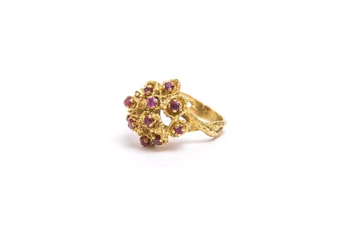 18K Gold and Ruby Ring: A 18K gold and ruby cluster ring.