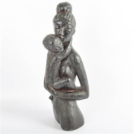 Vintage Mother and Child Sculpture: A vintage molded plaster sculpture of a mother and child. The sculpture has a black finish and depicts the torso of a mother holding an unclothed baby with its hands around her neck. The back of the base in incised “Leonardo Art” and it is felted at the base.
