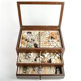 Generous Vintage Costume Jewelry Collection Including Coro, Lisner and Weiss: A generous collection of vintage costume jewelry. Includes an assortment of clip-on earrings, necklaces and rings in silver tone, gold tone, rhinestones and more. Notable brands include Coro, Weiss and Lisner with the majority of pieces unmarked. Includes a tabletop jewelry box with divided storage.