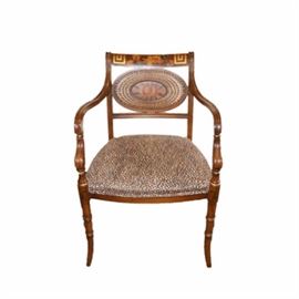 Vintage Hand-Painted Chair With Leopard Upholstery: A vintage hand-painted chair. The walnut stain chair features a straight top rail and oval back woven wicker back; both with hand-painted flowering botanical design. Other features include high round front arms with ring turned accents and tapered legs. The seat is upholstered in leopard print.