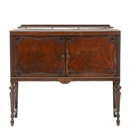 Vintage Mahogany Server: A vintage mahogany server with two doors with scrolled borders, over turned and carved legs with stretchers. Unmarked.