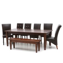 Pine Dining Table with Bench and Chairs: A contemporary dining table, in pine with a dark stained finish. It includes a matching bench and six chairs upholstered in dark brown leather. The chairs are in the same color but are not all identical in some details of style.