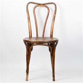 Austrian Antique Thonet Style Bentwood Chair: An Austrian antique Thonet style bentwood chair. This chair features bentwood legs and backrest with arched leg supports and a round seat with wooden, steam-pressed floral motif. One side of the seat bears a mark for “Jo. J. Kohk” followed by an indiscernible word and “Austria”.