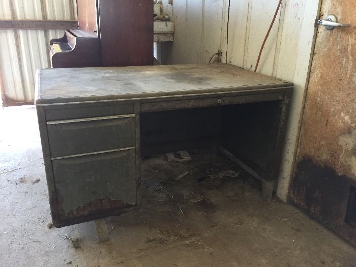 1940s metal and leather-top desk. It looks great with the age and damage.