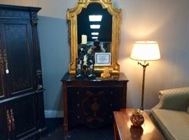 Two matching black pieces of furniture with painted decor on fronts