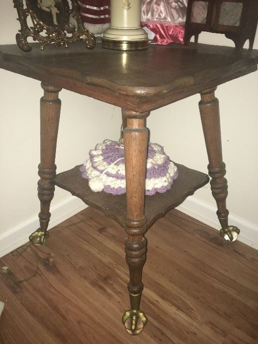 oak table with glass ball and brass claw feet