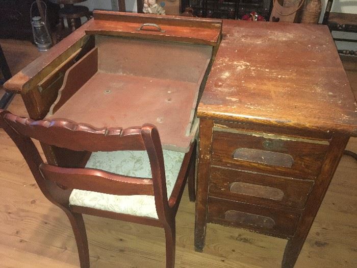 Very old Oak typing desk that fold out for type writer and folds back for easy storage. 