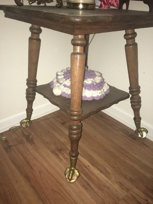 Oak table with glass balls and brass claw feet