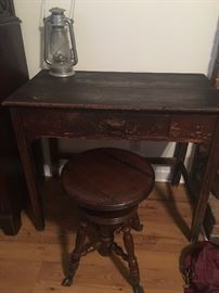 very old primitive desk , piano stool with glass balls and brass claw feet and lantern