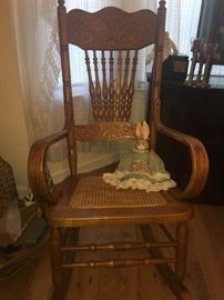 nice Oak rocker with spool back and cane bottom with antique bunny
