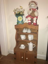 beautiful primitive cabinet with tea set and craft bunny and beautiful floral accent