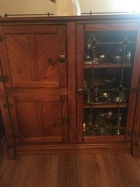 Nice Oak buffet with leaded glass and two left side doors . brass rails go all the way around the top of the buffet on all three sides. 