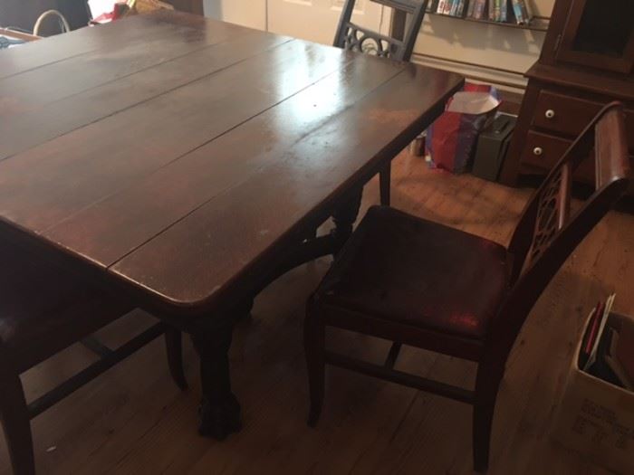 large best dining table with six  matching chairs and additional center leaf- tiger oak- large claw feet on table 