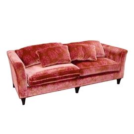 Dapha Contemporary Style Sofa: A Dapha contemporary style sofa. This piece features mid-century modern styling. It is upholstered in a mauve colored velvet-like fabric with a pink turtle shell print. The cushions are removable, and two matching pillows are included. It stands on tapered legs in an espresso finish. The label reads “Dapha”.