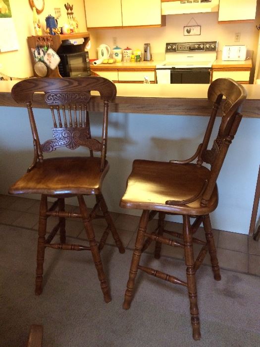 Pair of oak swivel bar stools