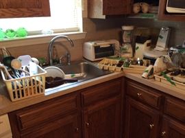 More kitchen appliances, sink strainer, silverware, etc
