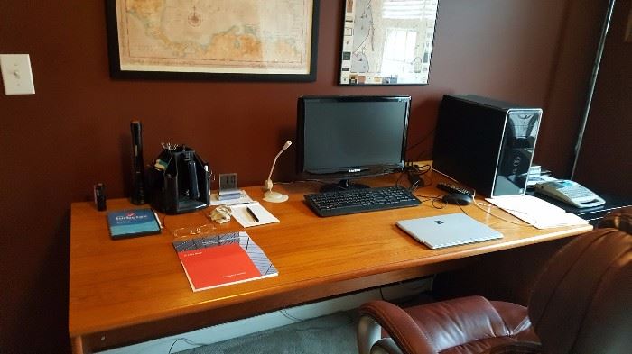 wooden desk, computer, leather chair, framed map