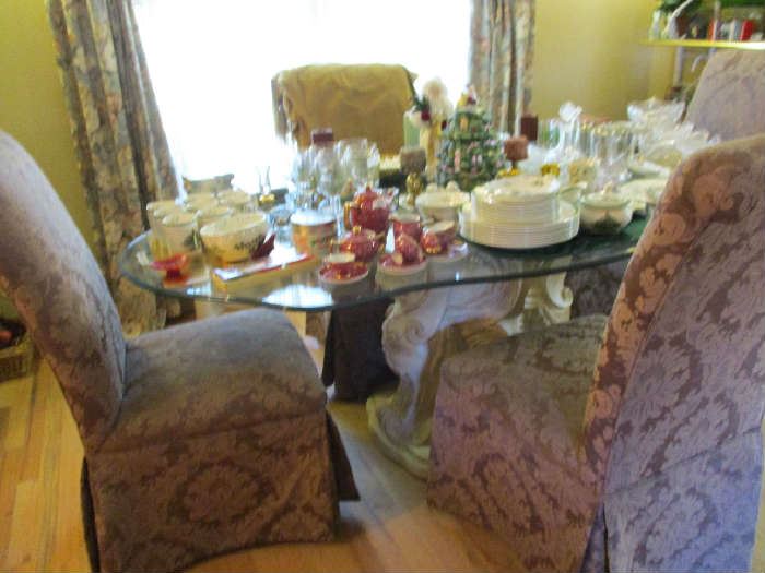 Very nice looking glass top table with 4 chairs