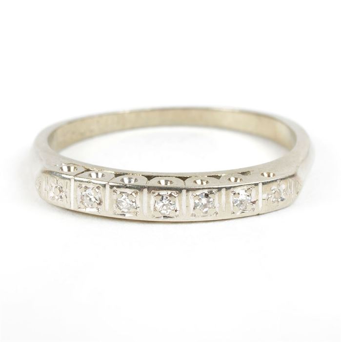 18K White Gold Diamond Band: An 18K white gold diamond band. This women’s ring features bright-cut set diamonds in an 18K white gold shank and squared shoulders.
