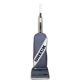 Oreck XL Xtended Life Model XL988 Vacuum Cleaner: An Oreck XL Xtended Life model XL988 vacuum cleaner. This standing vacuum cleaner as a white cord and light blue body with a silver tone and white handle. It has a large bag to the front and the body can lean up and down from the head.