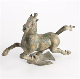 Chinese-Inspired Iron Horse Statue: A Chinese-inspired iron horse statue. Depicting an image of a prancing horse, this iron statue stands on a bird-shaped base. No visible maker’s mark.