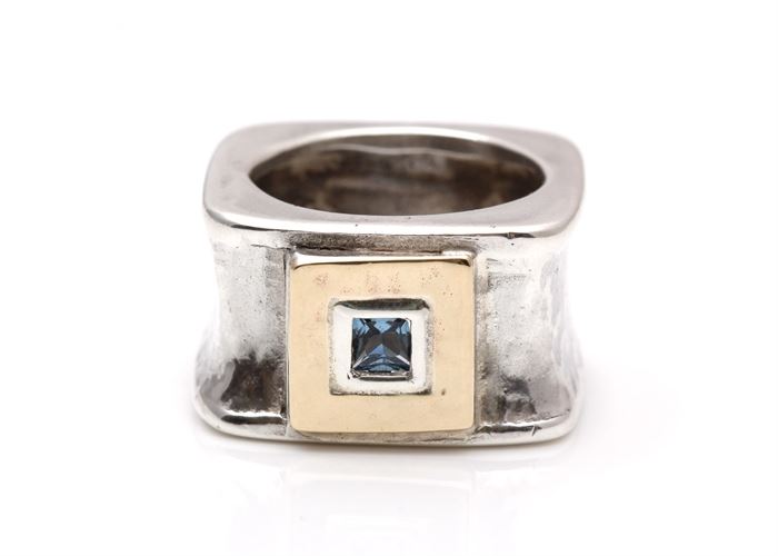 Sterling Silver 14K Gold Accented Blue Topaz Ring: A square hammered sterling silver band is enhanced by a yellow gold square accent to the center with bezel set blue topaz.