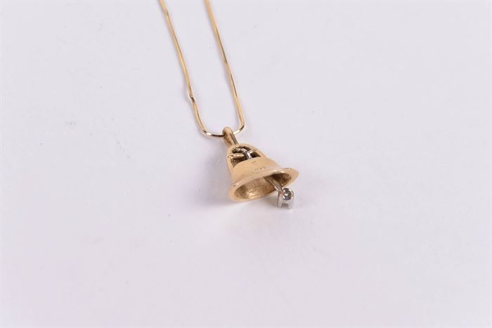 14K Gold Bell Pendant With Diamond and 10K Gold Chain: A 14K gold bell pendant with diamond and 10K gold chain.