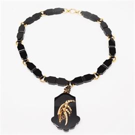 Antique 14K Yellow Gold Onyx and Seed Pearl Pendant Necklace: An antique 14K yellow gold onyx and seed pearl pendant necklace. Necklace features onyx links with gold rings, and includes an onyx pendant with a lily-of-the-valley seed pearl design.