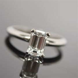 Platinum 1.06 Cts Diamond Solitaire Ring With GIA Certificate: A platinum 1.06 ctw diamond solitaire ring with GIA certificate #11807963. This emerald cut diamond is set in a basket head on a rounded profile shank.