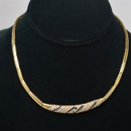 Fred Joaillier 18K Yellow Gold Diamond and Sapphire Necklace: A French 18K yellow gold diamond and sapphire necklace by FRED Joaillier. This choker length necklace features channel set sapphires and bead and bright set diamonds, on a curved link chain. FRED Paris Joaillier is known for jewelry made specifically for many films and celebrities.