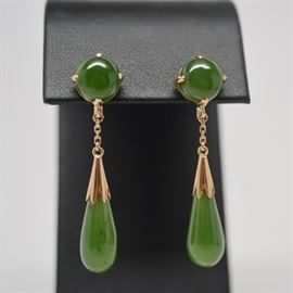 Vintage 14K Yellow Gold Nephrite Dangle Pierced Earrings: A pair of vintage 14K yellow gold nephrite dangle pierced earrings. Earrings feature a nephrite round cabochon stone at the ear, with a gold chain and findings at the nephrite drop cabochon.