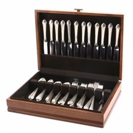 Alvin Sterling Silver Flatware Set with Case: An Alvin sterling silver set in a light wood case. Included in this set are twelve dinner knives, twelve spoons, twelve soup spoons, twelve salad forks, twelve dinner forks, and a serving spoon. Also included are two souvenir spoons and a baby spoon. Total approximate weight of all pieces including nonmetal materials is 57.64 ozt.